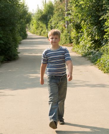 The little boy goes on a roadの写真素材