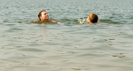 Mom and son swimming in the seaの写真素材