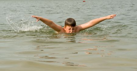 the little boy quickly swims the butterfly strokeの写真素材