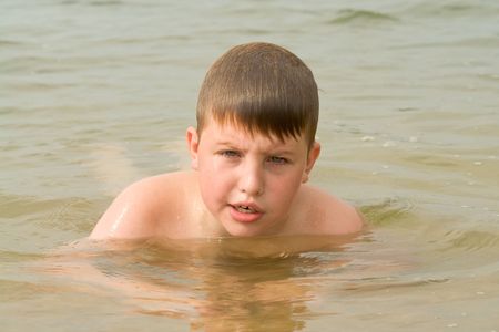 the little boy swims in the seaの写真素材