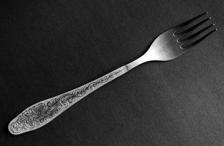 silver dinner fork on a black backgroundの写真素材