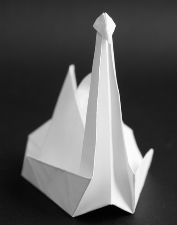 paper crane - simple origami on a black backgroundの写真素材
