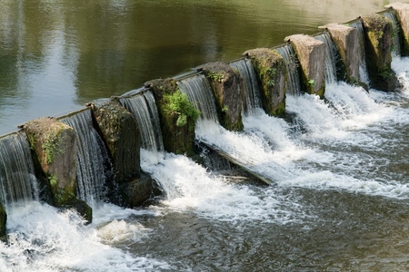 the cascade. Overflow dam on small riverの写真素材
