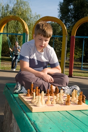 little boy play a chess in parkの写真素材