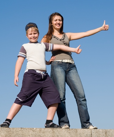 Family with thumb up on a sky backgroundの写真素材