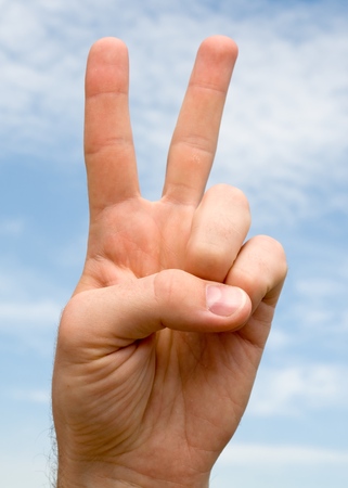 Two. Human hand on a blue skyの写真素材