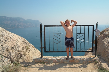 little boy against mountains and the seaの写真素材