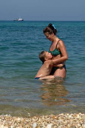 Mum and the son on the beachの写真素材