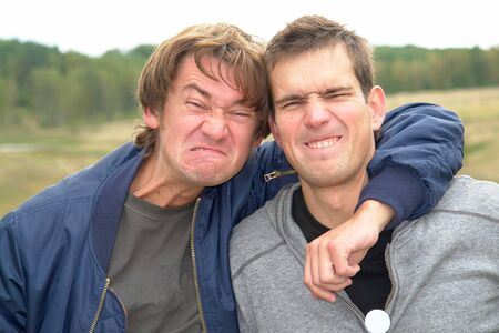 I can make this face&#8230; Two young men pull facesの写真素材
