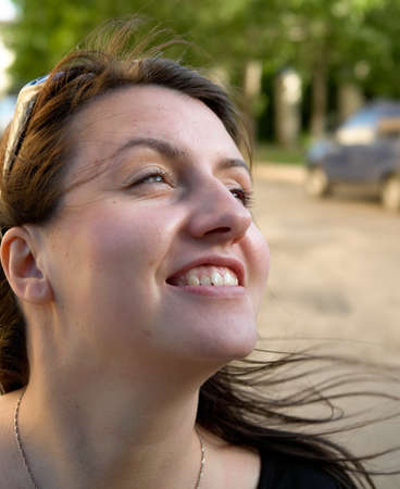 The smiling young woman against green parkの写真素材