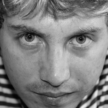 Sad young man close up. Black &#8211; and - white portrait.の写真素材