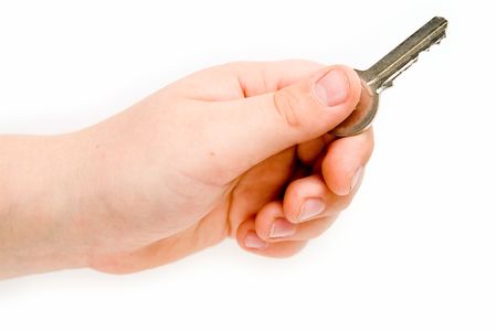 Hand with a key on a white backgroundの写真素材