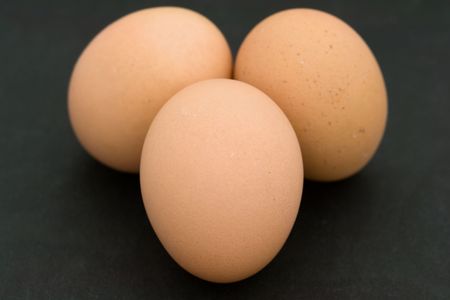 Three eggs on a black background