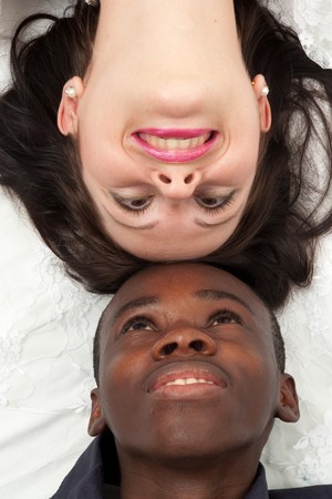 Two faces close up. Black man and white woman.の写真素材