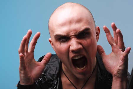 Portrait of a goth man on a blue backgroundの写真素材