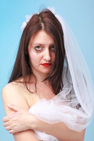 Sad young bride with running make up
