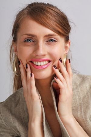 Fetching smile. Beautiful young woman close up.の写真素材