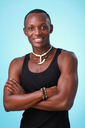 Smiling young man on a blue backgroundの写真素材