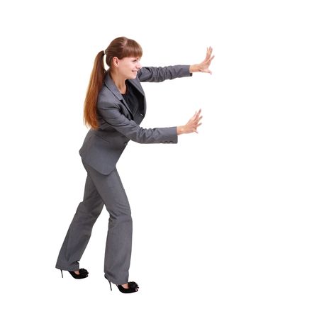 Business woman pushing something, isolated on a white background with copyspaceの写真素材