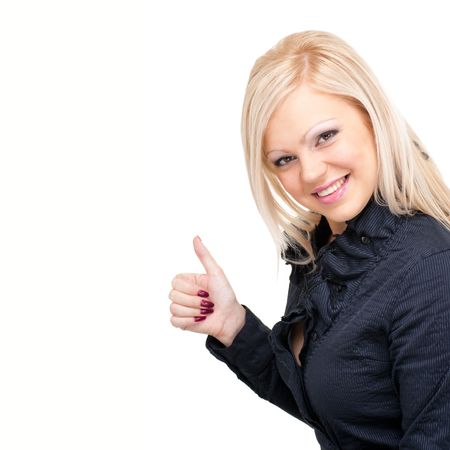 Smiling woman with thumbs up gesture. Isolated over white background, with copyspace.の写真素材