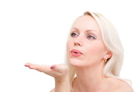 Beautiful young woman with kissing gesture on a white background with copyspace.の写真素材