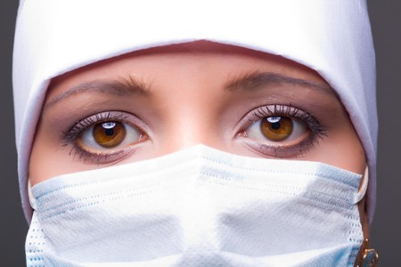 Closeup portrait of a young doctor wearing a maskの写真素材