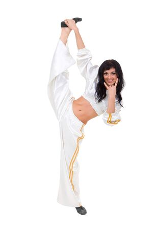 Smiling dancer makes split against isolated white backgroundの写真素材
