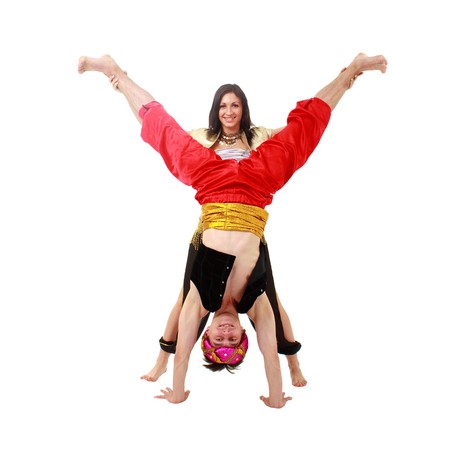 Happy couple dancing belly dance isolated on white backgroundの写真素材