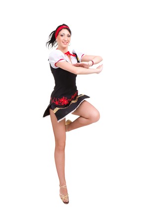 Attractive woman wearing a folk russian dress jumping against isolated white backgroundの写真素材