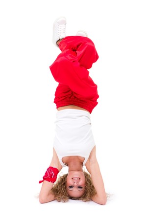 hip-hop dancer stands on her head isolated on white backgroundの写真素材