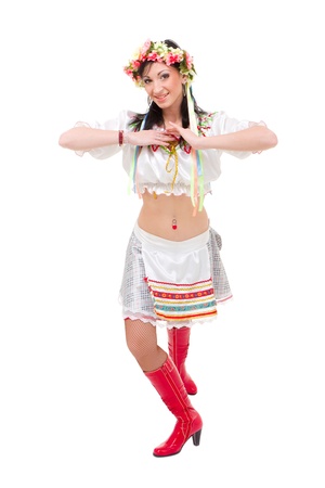 Attractive woman wearing a folk ukrainian dress dancing against isolated white backgroundの写真素材