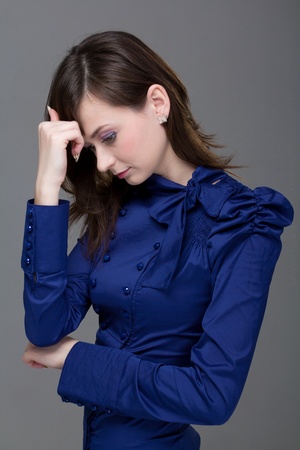woman with headache on a gray backgroundの写真素材