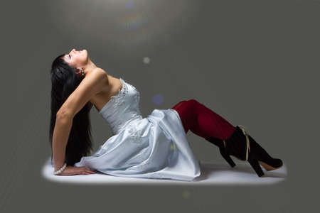 Young bride posing on a gray backgroundの写真素材
