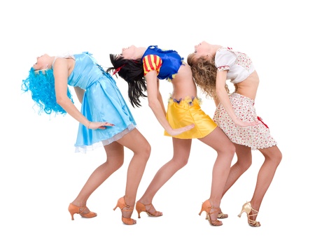 Three girls dressed in puppet dancing on a white backgroundの写真素材