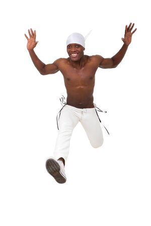 Happy young man jumping against isolated white backgroundの写真素材