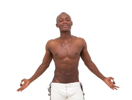 handsome young man meditating against isolated white backgroundの写真素材
