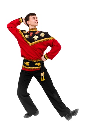 young dancer wearing a folk russian costume dancing against isolated white backgroundの写真素材