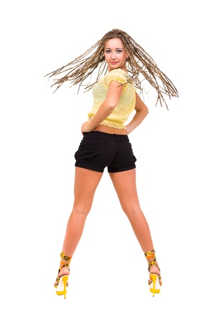 Happy young woman with dreadlocks standing against isolated white background  の写真素材