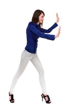 Beautiful woman pushing something, isolated on a white background with copyspace の写真素材