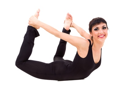 Young smiling acrobat posing against isolated white backgroundの写真素材