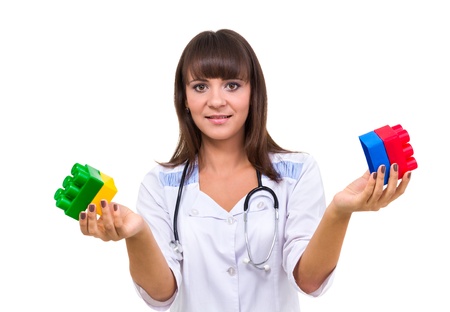 Young medic pediatrician with toys isolated on white backgroundの写真素材