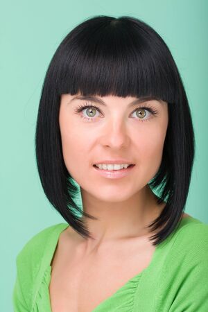Closeup portrait of a beautiful female model against green backgroundの写真素材