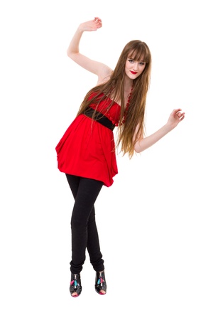 Portrait of young woman in red dress smiling against white backgroundの写真素材