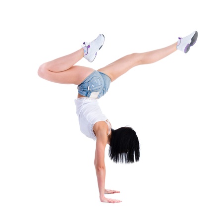 woman does a gymnastic handstand  Isolated on white background in full length  