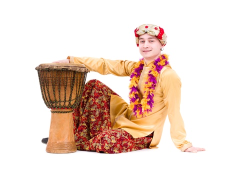 full length portrait of indian man with a drum in studio   Isolated on white background 