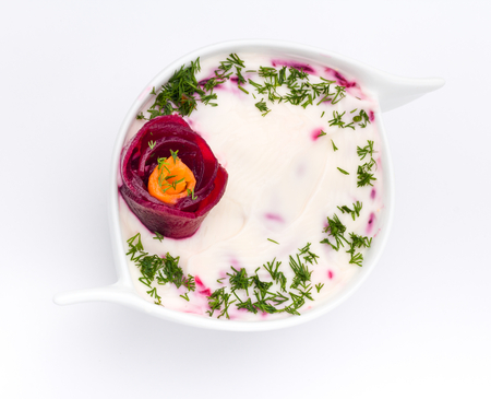 Cold soup with beets , carrots, yogurt and fresh herbs on whiteの写真素材