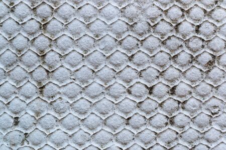 Background texture of old gray concrete fence with hexahedron pattern