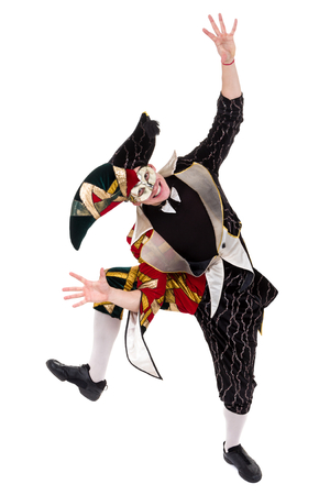 Smiling harlequin wearing a mask, isolated on white background in full length.の写真素材