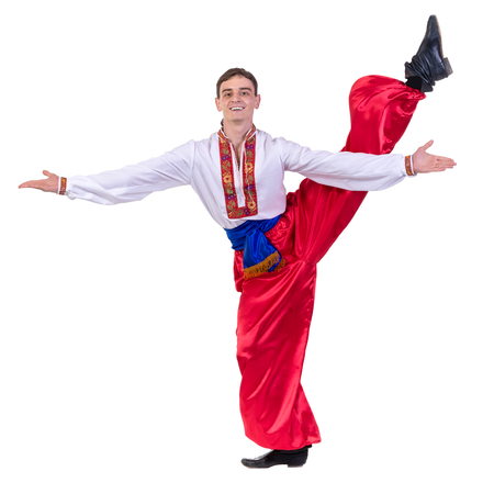 young man wearing a folk russian costume dancing against isolated white background with copyspaceの写真素材