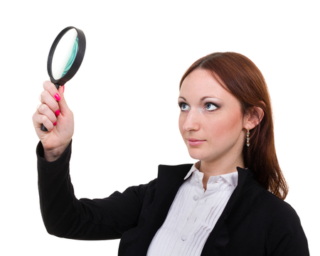 hocked woman searching finding clues with magnifying glass, isolated on whiteの写真素材